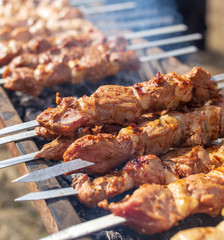 Shish kebab on skewers is fried on a brazier