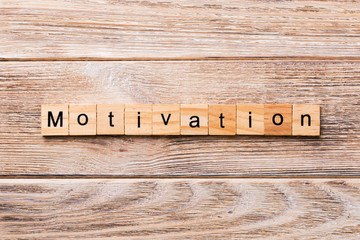 Motivation word written on wood block. Motivation text on wooden table for your desing, concept