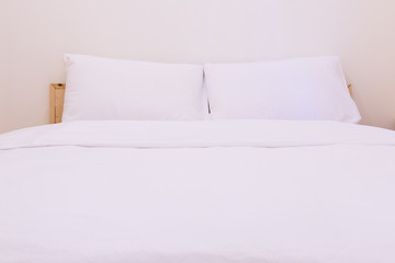 White pillow on bed and the clean blanket is good to sleep in the bedroom interior,fresh bed concept