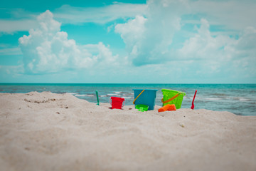 kids toys on tropical sand beach, family vacation