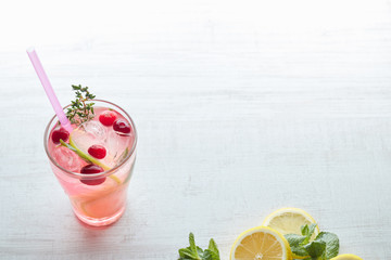 Lemonade with ice and fresh lemon with mint on wooden background. horizontal view. copy space. close-up. refreshing summer drink.