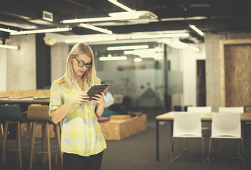 blonde businesswoman working online using digital tablet