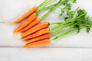 Fresh and sweet carrot on a grey wooden table