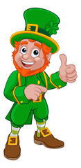 A Leprechaun St Patricks Day Irish cartoon character pointing and doing a thumbs up