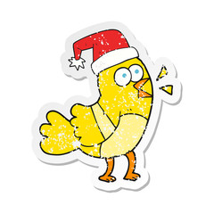 retro distressed sticker of a cartoon bird wearing christmas hat