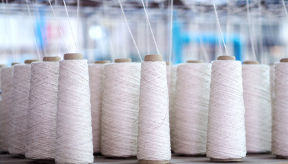 Row of textile threads industry .