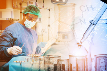 Doctor working in the operating room with dropping chemical liquid to test tube, medical research...