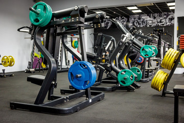 empty gym for fitness and bodybuilding with fitness equipment and dumbbells.