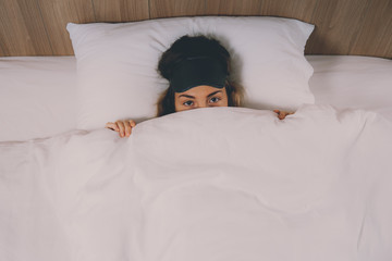 pretty young female in snow-white bed, wakes up in wonderful summer morning,