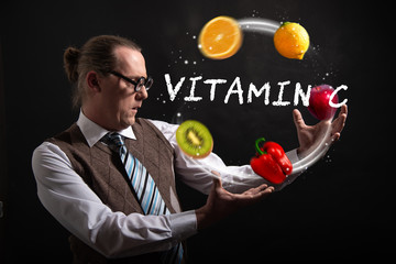 Funny nerd or geek juggles with fruits and vegetables vitamin c