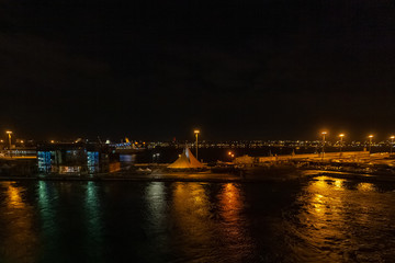 Fototapeta na wymiar Night view of the Bari harbor with moored ferry, Italy