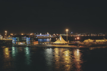 Fototapeta na wymiar Tilt shift effect of night view of the Bari harbor with moored ferry, Italy