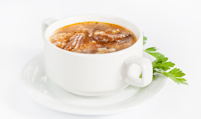 Bowl with delicious soup with meat and barley on white