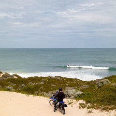 Motor cycle rider checking surf