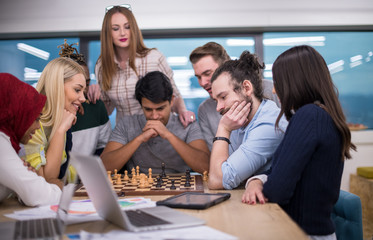 multiethnic group of business people playing chess