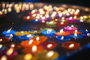 Fototapeta na wymiar Lotus candle lit and floating on water. 