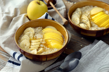 Healthy breakfast Oatmeal fruits honey Rustic style