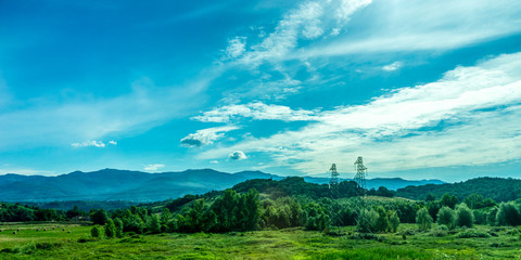 Italy, Rome to Florence train, a large green field with a mountain in the background