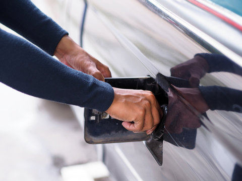 Closeup Hand Man Pumping Gasoline Fuel In Car At Gas Station.