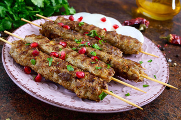 Lula kebab is a traditional Arabic dish. Meat shashlik on wooden skewers.