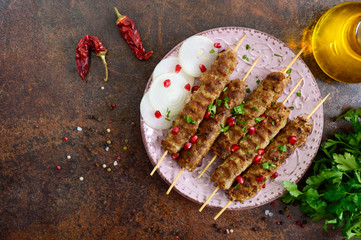 Lula kebab is a traditional Arabic dish. Meat shashlik on wooden skewers. The top view