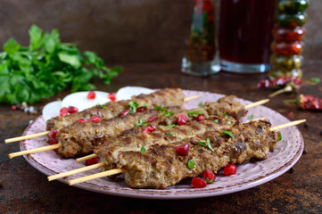 Lula kebab is a traditional Arabic dish. Meat shashlik on wooden skewers.