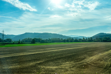 Obraz premium Italy, Rome to Florence train, a large green field with trees in the background
