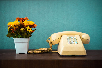 Old telephone with dust and scratches with vintage green background, retro style concept