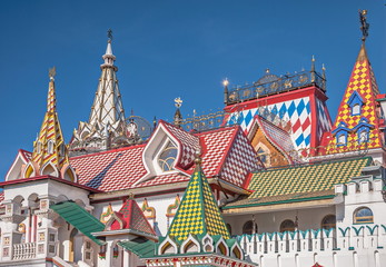 Bright painted tower with turrets, porches and weather vanes -  sample of ancient Russian architecture