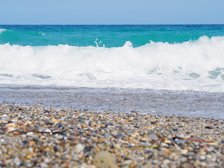 Sea stones and blue storm sea background.Sunny day.