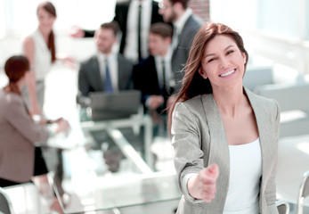 smiling business woman inviting you into her office