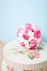 Fototapeta na wymiar Wedding roses in vintage style - bouquet - blue background.