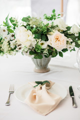 wedding table decorated by plates, knives and forks