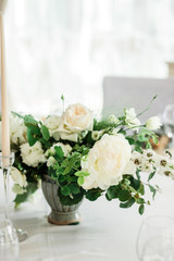 wedding table decorated by plates, knives and forks