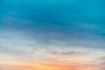 Sunset sky with violet yellow light clouds. Colorful smooth blue sky gradient. Natural background of sunrise. Amazing heaven at morning. Slightly cloudy evening atmosphere. Wonderful weather on dawn.