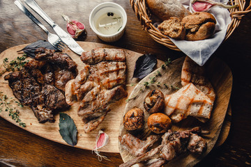 Different types of grilled meat: marbled beef, pork, chicken pieces. Serving meat dishes at the restaurant.