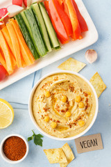 Hummus dip served with fresh vegetable sticks.