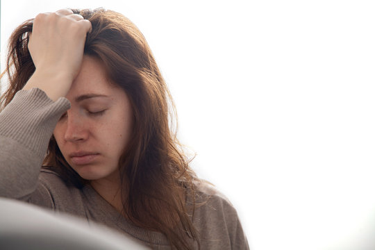 Young attractive woman in depression with a headache.