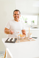 Middle age man eating asian food at home