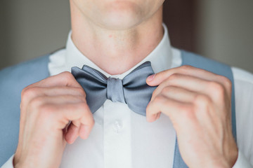 Grooms morning preparation, handsome groom getting dressed