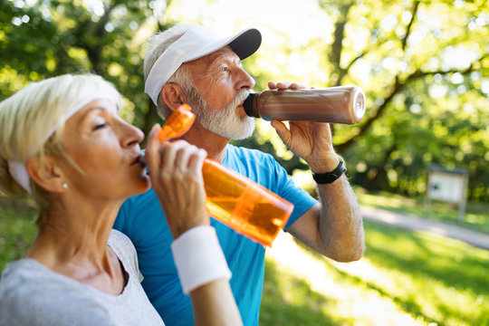 Senior couple staying hydrated after running jogging