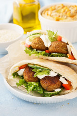 Healthy vegetarian falafel pita with fresh vegetables and hummus