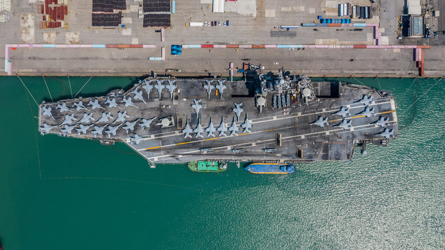 Navy Nuclear Aircraft carrier, Military navy ship carrier full loading fighter jet aircraft, Aerial view.