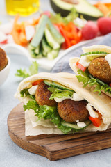 Healthy vegetarian falafel pita with fresh vegetables and sauce