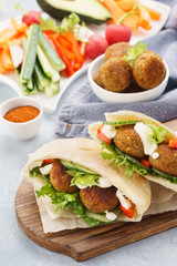 Healthy vegetarian falafel pita with fresh vegetables and sauce