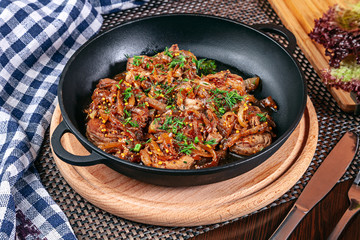 Close up view on served homemade meat and vegetables in cast iron pot. Flat lay food. Ukrainian...