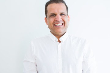 Middle age man smiling confident to the camera at home