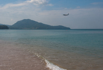 Airplane landing over sea at Mai Khao airport