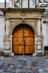 Beautiful bivalve wooden massive door in the old historic house. © Alona Dudaieva
