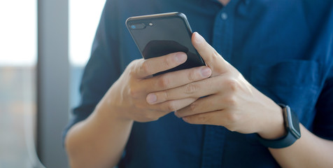close up businessman using smartphone for working 